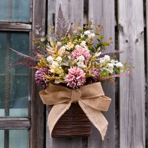 Detailed closeup of artificial wall hanging flower basket with rustic burlap bow and greenery.