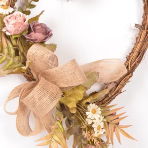 Detailed view of the vintage heart-shaped twig wreath with pink roses and burlap bow.