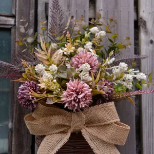 Artificial flower wall hanging basket detail, rustic wicker bouquet home decor.