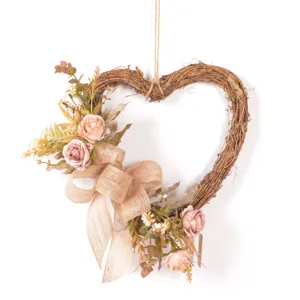 Vintage heart rattan wreath with artificial roses and burlap bow for door and wall decor.
