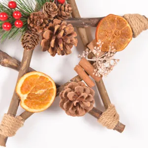 Vintage wooden star Christmas wreath with pinecones and dried orange slices for holiday decor.