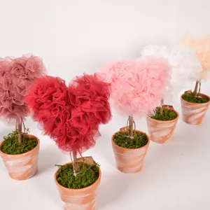 Detail view of cute heart-shaped mesh potted plant, perfect for wedding or Valentine decor.