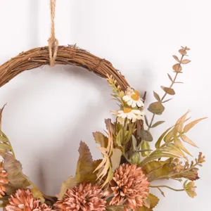 Close up of autumn artificial floral wreath with rustic dried twigs and vintage leaves.