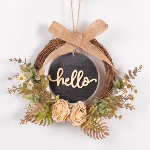 Autumn vintage artificial wreath detail with rattan, burlap bow and hello wooden sign.