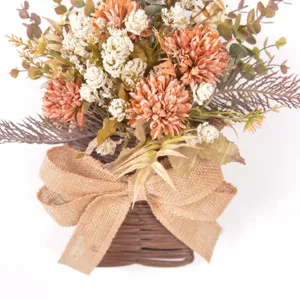 Artificial flower wall hanging detail, realistic bouquet and woven basket decor.