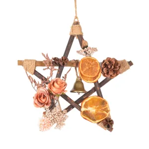 Retro wooden star Christmas wreath hanging ornament with dried fruit slices and pine cones.