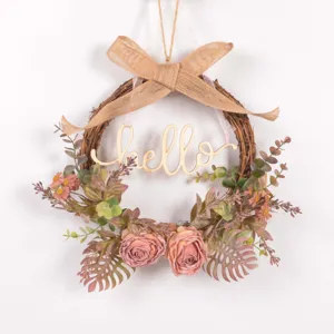 Autumn vintage floral wreath detail, rustic twig base with artificial roses and eucalyptus.