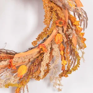 Close up of autumn artificial floral wreath detail, rustic harvest festival front door hanging.