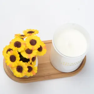 Decorative wooden tray set with artificial sunflower potted plant and scented soy candle.