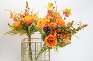 Autumn artificial flower bouquet detail with fake roses and pine cones in vase decor