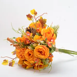Close-up detail of autumn artificial flower bouquet with orange roses and pinecones for decor.