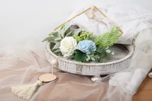 Detailed view of Nordic wall hanging decor with artificial roses, iron frame and wooden tray.