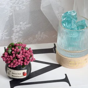 Charming artificial mini potted plant with vibrant pink berries, ideal for desk and home decor.