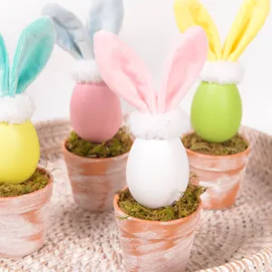 Easter egg bunny potted plant detail view featuring cute plush rabbit ears and green moss.