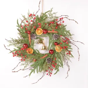 Detailed view of a retro Christmas wreath with faux pine needles, dried oranges, and pinecones.