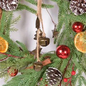 Rustic Christmas wreath decoration with fake pine needles, dried orange slices and pine cones.