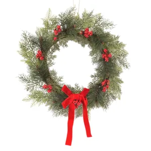 Christmas wreath with artificial pine branches red berries and velvet bow for door wall decor