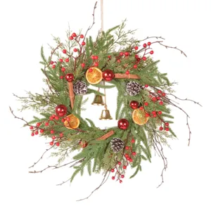Retro Christmas wreath with pine needles, dried orange slices and berries for door decor.