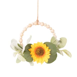 Artificial sunflower wreath with wooden beads and eucalyptus leaves for home wall decor.