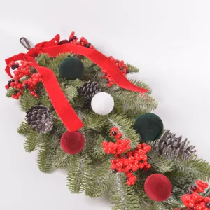 Detail view of artificial Christmas teardrop swag with pinecones, red berries and velvet balls.