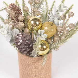 Close-up detail of Christmas pinecone berry bouquet in burlap pot for holiday decor.