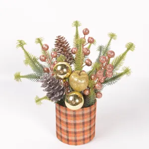 Christmas desktop decorative potted plant with artificial pine branches glitter berries and cones.