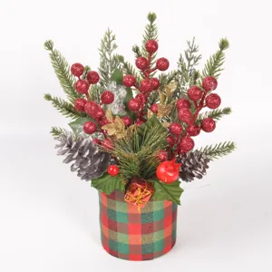 Close-up detail of Christmas artificial pine branches, red glitter berries, and plaid pot decor.