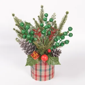 Christmas desktop plant detail showing pine branches, glitter berries, pinecones and plaid pot.