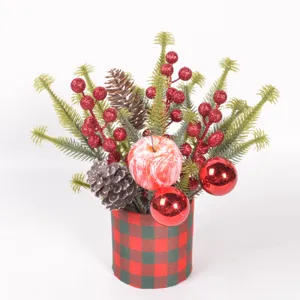 Close-up detail of Christmas desktop decoration, miniature pine branches, glitter berries, plaid pot.