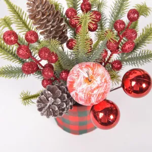 Christmas desktop potted plant decoration with pine branches, glitter berries, and red balls.