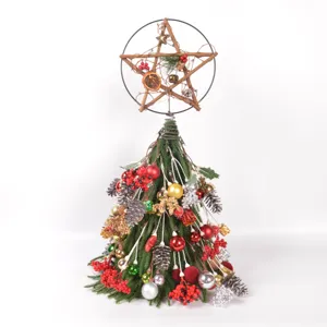 Christmas tree table decoration with pine cones berries and star topper for holiday gifts
