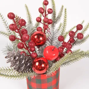 Christmas tabletop potted plant decor with artificial pine branches, berries, and ornaments.