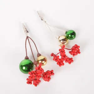 Christmas decorative clip detail view showing shiny ball and red berry branch.