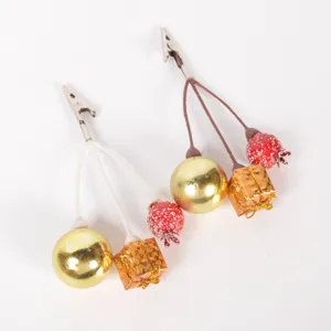 Christmas decorative clips with gold balls and gift box ornaments for tree decor.