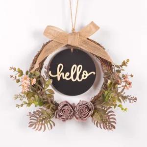 Detailed view of autumn vintage artificial flower wreath with hello sign and eucalyptus leaves.