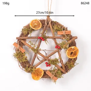 Detailed view of the Christmas rustic pentagram twig wreath decorated with moss and dried oranges.
