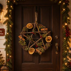 Rustic Christmas twig wreath with dried orange slices, moss and cinnamon detail view.