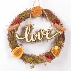 Rustic Christmas vine wreath with dried orange slices, moss, cinnamon and Love wooden sign.