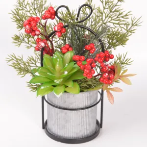 Artificial succulent red berry potted plant detail view, metal bow shelf, Christmas decor.