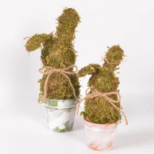 Easter moss rabbit figurine detail shot, rustic plant pot tabletop holiday decoration piece.