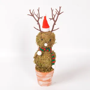 Close-up detail of the moss reindeer figurine featuring a Santa hat and cute festive scarf.