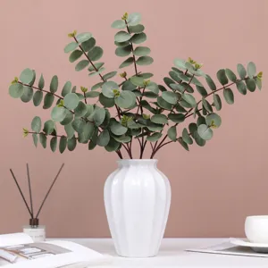 Artificial eucalyptus leaves in white ceramic vase table floral arrangement wedding decor