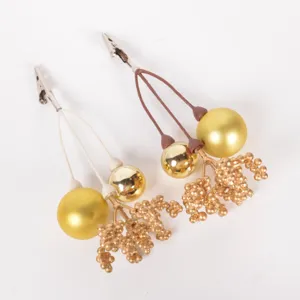 Christmas decorative clip detail showing gold balls and berry branches for festive gift boxes.