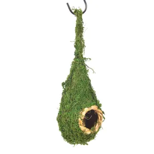 Natural moss hanging bird nest detail, handcrafted straw birdhouse for garden decor.