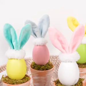 Detailed close-up of cute Easter bunny egg potted plants with moss and plush ears for home decor.