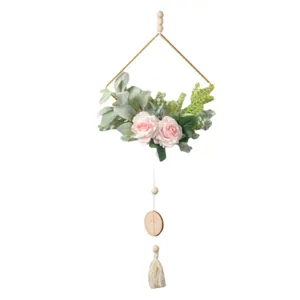 Nordic wall hanging decor with artificial pink roses, iron geometric frame, and wooden beads.