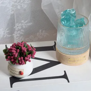 Mini artificial potted plant with pink berries in ceramic pot for home desktop decor.