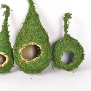 Detail view of natural moss hanging bird nest for garden decoration and pet bird habitat.