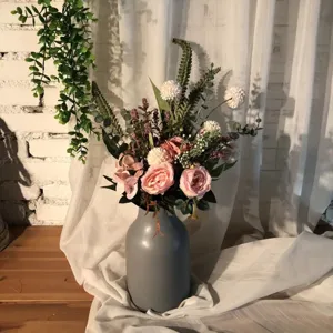 Artificial flower bouquet detail shot, vintage pink roses and grey vase for home decor.
