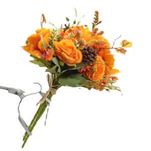 Artificial autumn flower bouquet with orange roses and pine cones for home decor.